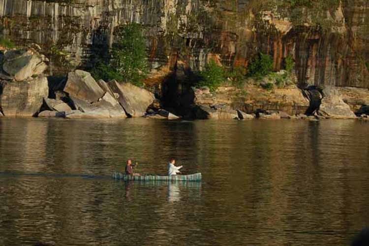 canoers in front of cliffs
